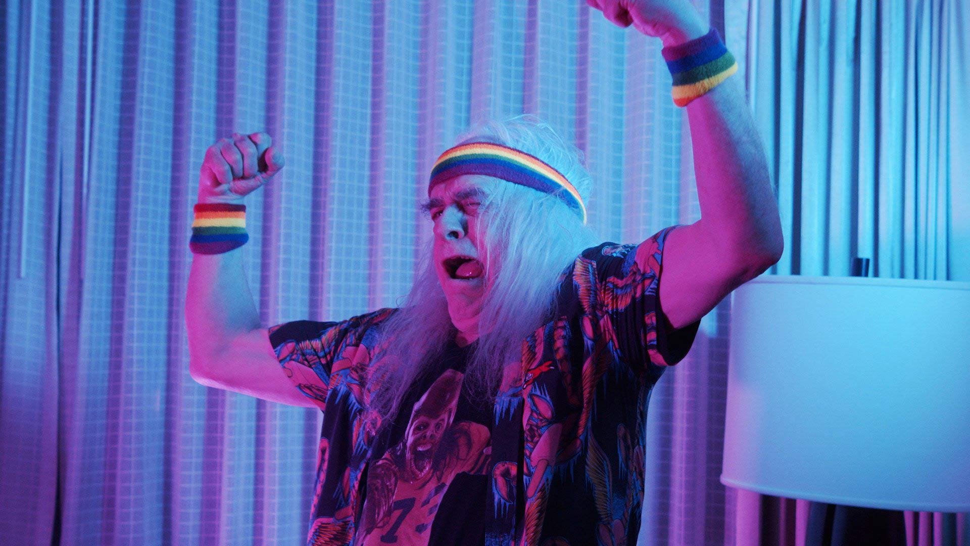 An older man with arms up in the air 