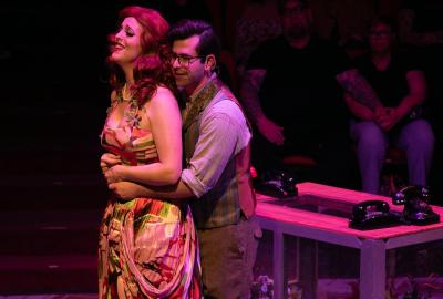 Couple hug in the Little House of Horrors Musical