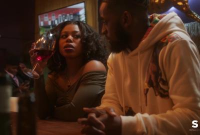 Gail Bean and Daniel Augustin at bar sipping wine