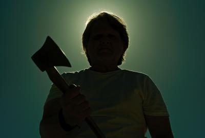 Silhouette of someone holding an axe
