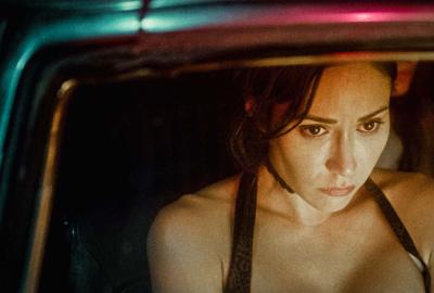 A woman sits in a car