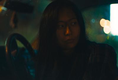 A woman driving looks back