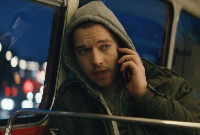 Thomas talks on his cell phone riding the bus