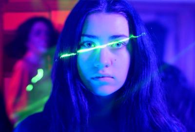 Clara looks on with lights on her face