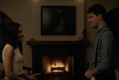 A couple stand in front of a fireplace with first date jitters.