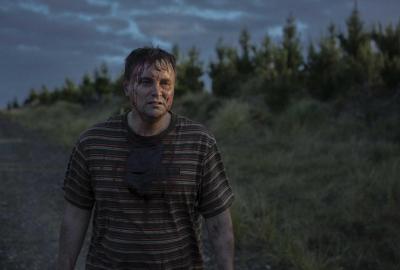 A bloodied man walks