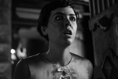 A woman looks on in fear