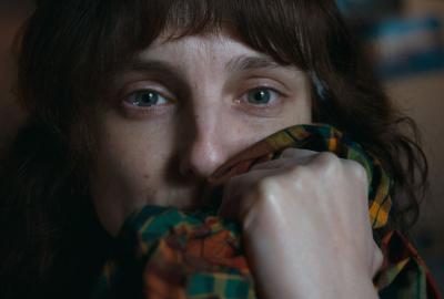 Cleo holds a shirt to her face