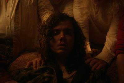 People place their hands on a young man