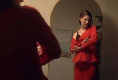 A woman cradles an invisible baby.