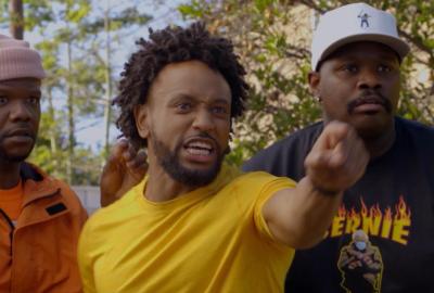 A man in a yellow shirt points