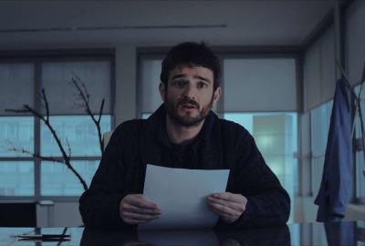 Artifitial man reading from paper