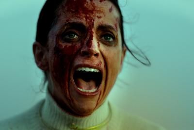 A bloody face woman screams