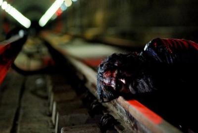 Stag Night bloodied person on the subway tracks