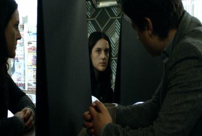 Unseen film still woman speaks with man using a mirror